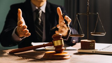 Business and lawyers discussing contract papers with brass scale on desk in office. Law, legal...
