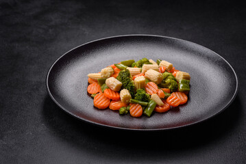 A mixture of vegetables: carrots, small heads of corn, asparagus beans steamed