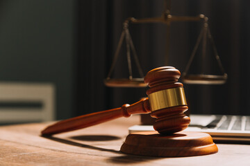 Business and lawyers discussing contract papers with brass scale on desk in office. Law, legal services, advice, justice and law concept picture with film grain effect