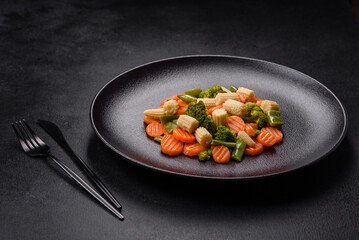 A mixture of vegetables: carrots, small heads of corn, asparagus beans steamed