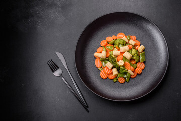 A mixture of vegetables: carrots, small heads of corn, asparagus beans steamed