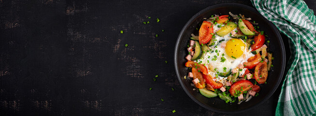 Ketogenic diet. Fried egg, ham and vegetables.  Keto breakfast. Brunch. Top view, flat lay