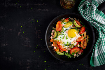 Ketogenic diet. Fried egg, ham and vegetables.  Keto breakfast. Brunch. Top view, flat lay