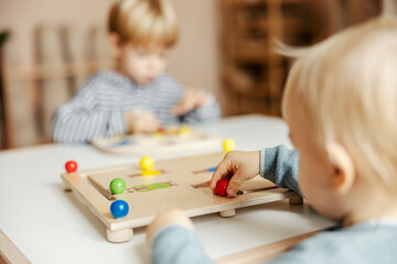 Close up of child playing with wooden educational game and learning colors.