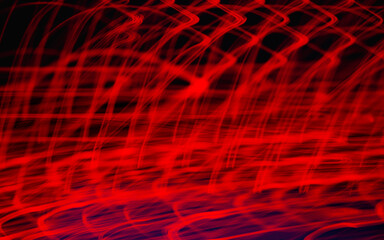 Beautiful colorful background.Long exposure light painting, curvy lines of different color in vibrant neon on black background. Glowing neon line designed background. Modern background. Abstract.