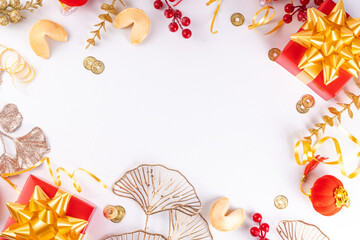 Chinese New Year on white background. Lunar New Year  greeting card with traditional festival decoration - ginkgo biloba, golden twigs, gift boxes, red berries, gift envelopes, coins, chinese lanterns