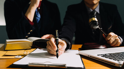 Business and lawyers discussing contract papers with brass scale on desk in office. Law, legal...