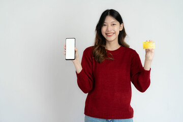 Asian woman holding smartphone and credit card on white background, name concept of online and paying