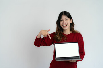 Obraz premium Asian young woman holding laptop computer on white background, online work concept