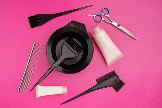 hairdressing accessories, set for cutting and coloring hair on a pink background