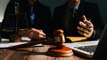 Business and lawyers discussing contract papers with brass scale on desk in office. Law, legal...