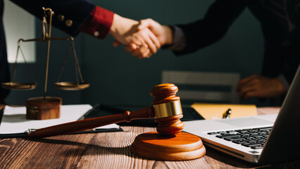 Business and lawyers discussing contract papers with brass scale on desk in office. Law, legal services, advice, justice and law concept picture with film grain effect