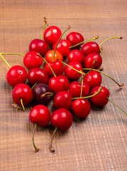 Fresh ripe cherries on wooden background