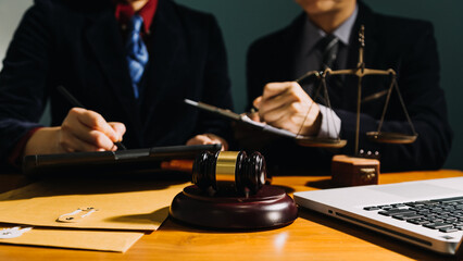 Business and lawyers discussing contract papers with brass scale on desk in office. Law, legal services, advice, justice and law concept picture with film grain effect