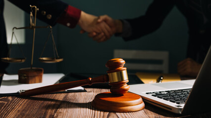 Business and lawyers discussing contract papers with brass scale on desk in office. Law, legal services, advice, justice and law concept picture with film grain effect