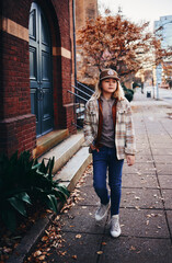 portrait of stylish teenage boy walking in downtown. street fashion. urban style