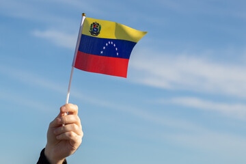 Venezuela flag in hand flutters in the wind against the sky, independence national day of Venezuela, country freedom, patriotism, Public Holiday, patriotic festival - obrazy, fototapety, plakaty