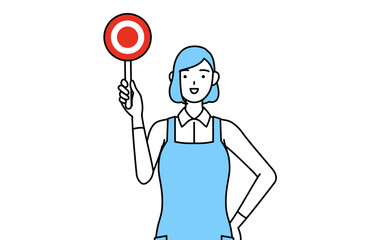 正解を示すマルの棒を持つエプロンを着た女性