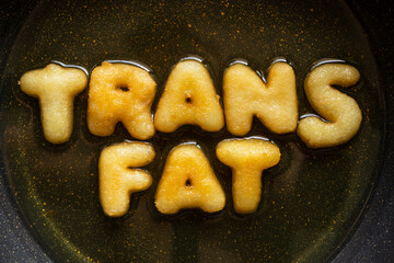 word TRANS FAT made from french fries in frying pan