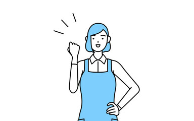 ガッツポーズをするエプロンを着た女性