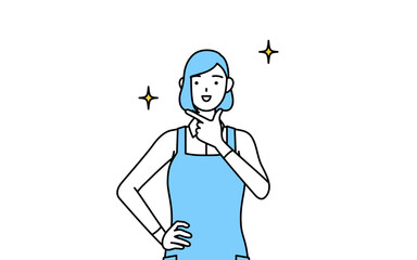 自信家のポーズを取るエプロンを着た女性