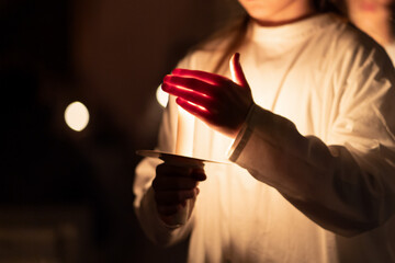 People handling candles in the hands. Christmas and lucia holidays
