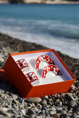 A box of porcelain cups and saucers on the pebble beach in Nice