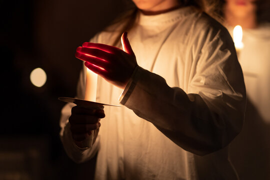 People handling candles in the hands. Christmas and lucia holidays
