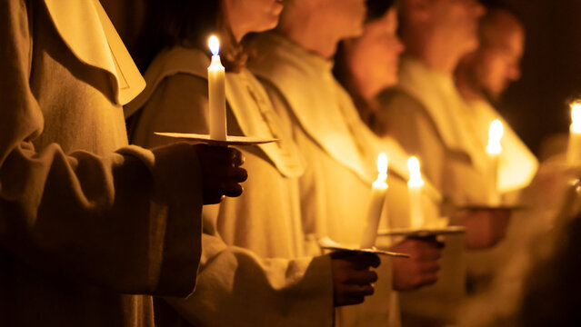 People handling candles in the hands. Christmas and lucia holidays