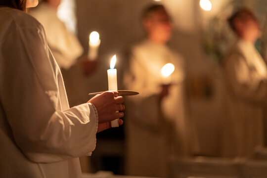 People handling candles in the hands. Christmas and lucia holidays