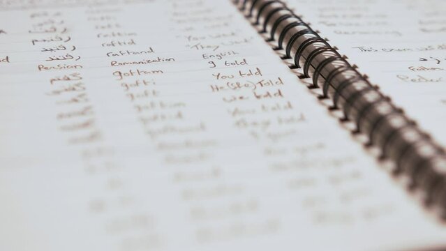 Learning Persian written verbs in organised notebook
