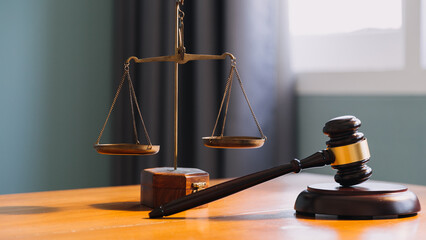 Business and lawyers discussing contract papers with brass scale on desk in office. Law, legal...