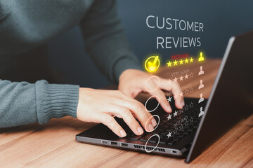 Businessman hand using computer laptop with popup five star icon for feedback review satisfaction...