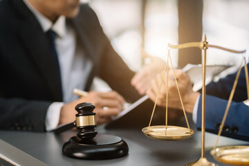 Lawyer signing important legal document on desk at office.