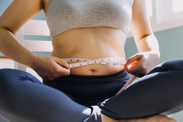 Beautiful fat woman with tape measure She uses her hand to squeeze the excess fat that is isolated...