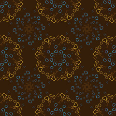 Seamless pattern of yellow and blue hearts flowers on a brown background. Print with hearts in kaleidoscopic ornamental style.