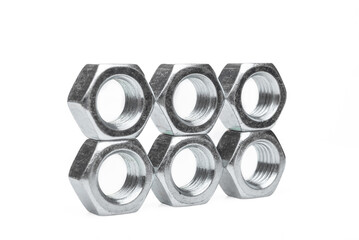 Set of steel nuts. On an isolated white background. With scratches. Close-up studio macro photography.