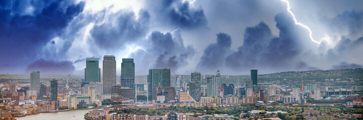 Obraz premium London - UK. Aerial panoramic view of Canary Wharf modern buildings during a storm