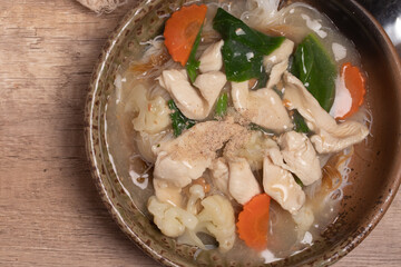 Thai Chicken and Gravy with vegetables poured over noodles.Thai food.