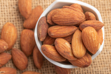 Salted almonds in a white cup.Copy space.