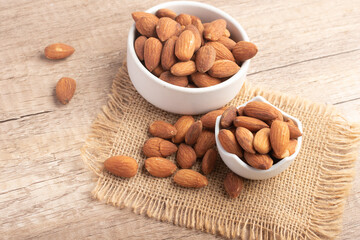 Salted almonds in a white cup.Copy space.