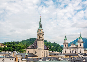 Fototapeta na wymiar City view with Franciscan church and Salzburg Cathedral, Salzburg, Austria.