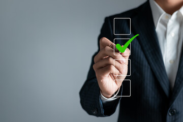 Checklist concept. Businessman checking mark on checkboxes, copy space..