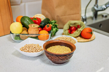 Veganuary vegan diet month in january. Education about veganism by encouraging people to follow a vegan lifestyle. Many Fresh raw food seasonal vegetables on home kitchen. Vegetarian, vegan food.