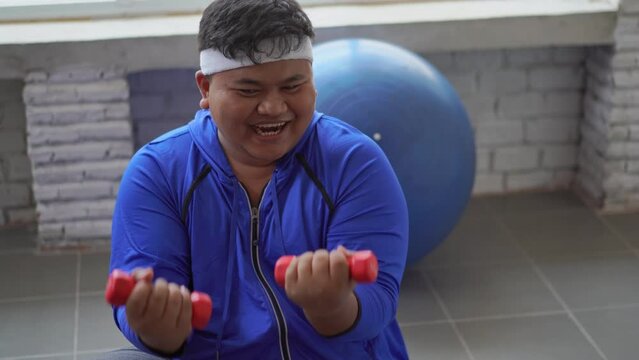 Fat men are exercising in the house.