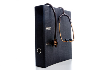 stethoscope hand on file binder a symbol for bureaucracy of cardiologists and doctors after...