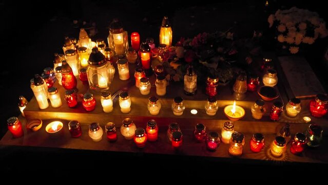 Candle Flames on Cemetery an Night, All Saint's Day , Death Holiday Lantern, 1 November Candles, Fallen Leaves, Blurred Background