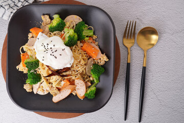 Stir-fried noodles with pork and egg, fresh vegetables, top view