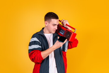 A handsome guy in the style of the 90s with a boombox on a yellow background