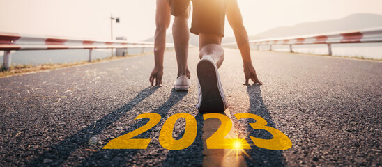 Young man asia running and sprinting on the road with new year 2023 text concept